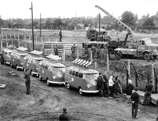 27 Jun 1962, Berlin, Germany --- The 'Schanz-commando' of East Germany's People's and Border Police is pictured in the midst of Eastern and Western sound trucks. Labour battalions of the Soviet Zone's People's and Border Police began erecting a new barrage out of prefabricated concrete slabs on June 27, 1962 at Klemkestreet on the border to West Berlin's quarter Reinickendorf. On the Western side of the border, next to the barbed-wire fence, the sound trucks of 'Studio am Stacheldraht' (literally: Studio alongside Barbed-Wire) drove up while labour battalions with 200 men gathered on the border's Eastern side in order to 'protect' with two water guns, an armoured personnel carrier, various armoured trucks and three army sound trucks. --- Image by © dpa/dpa/Corbis